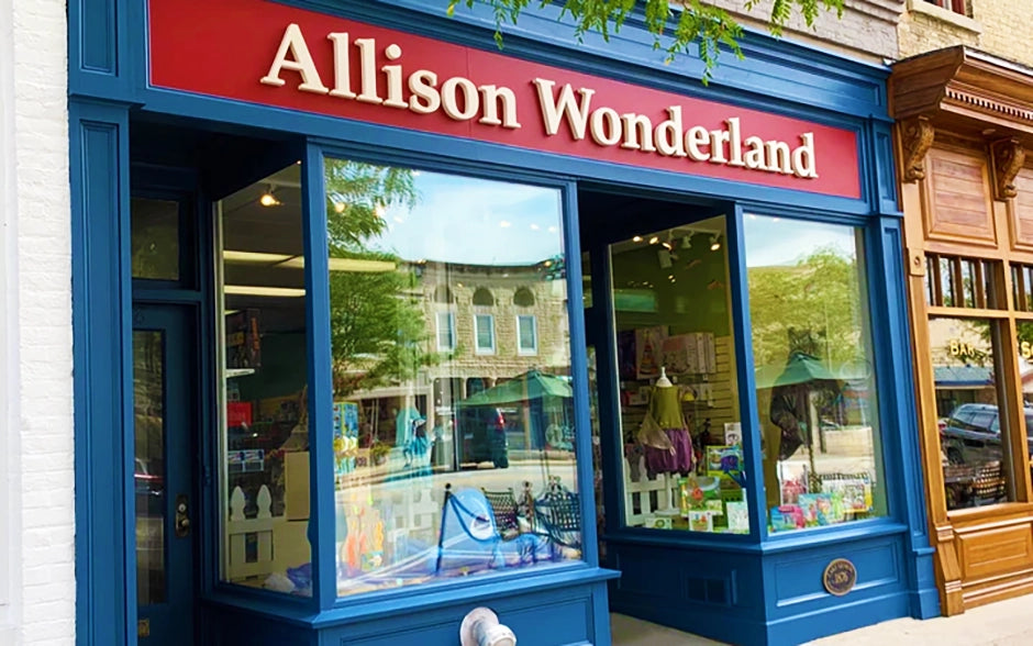 The burgundy and blue storefront and windows of Allison Wonderland Toys & Games Lake Geneva, WI location