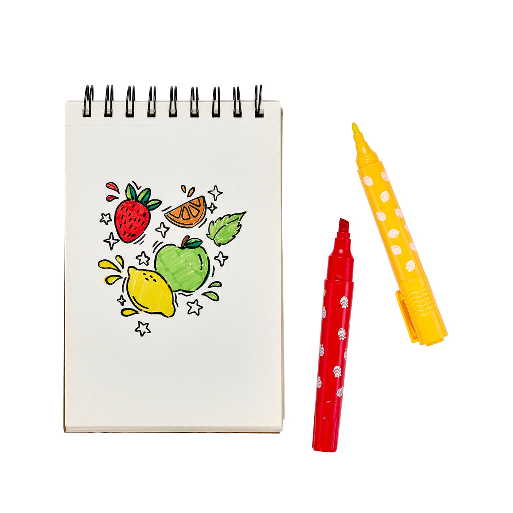 a sketchpad with drawings of fruit and two markers