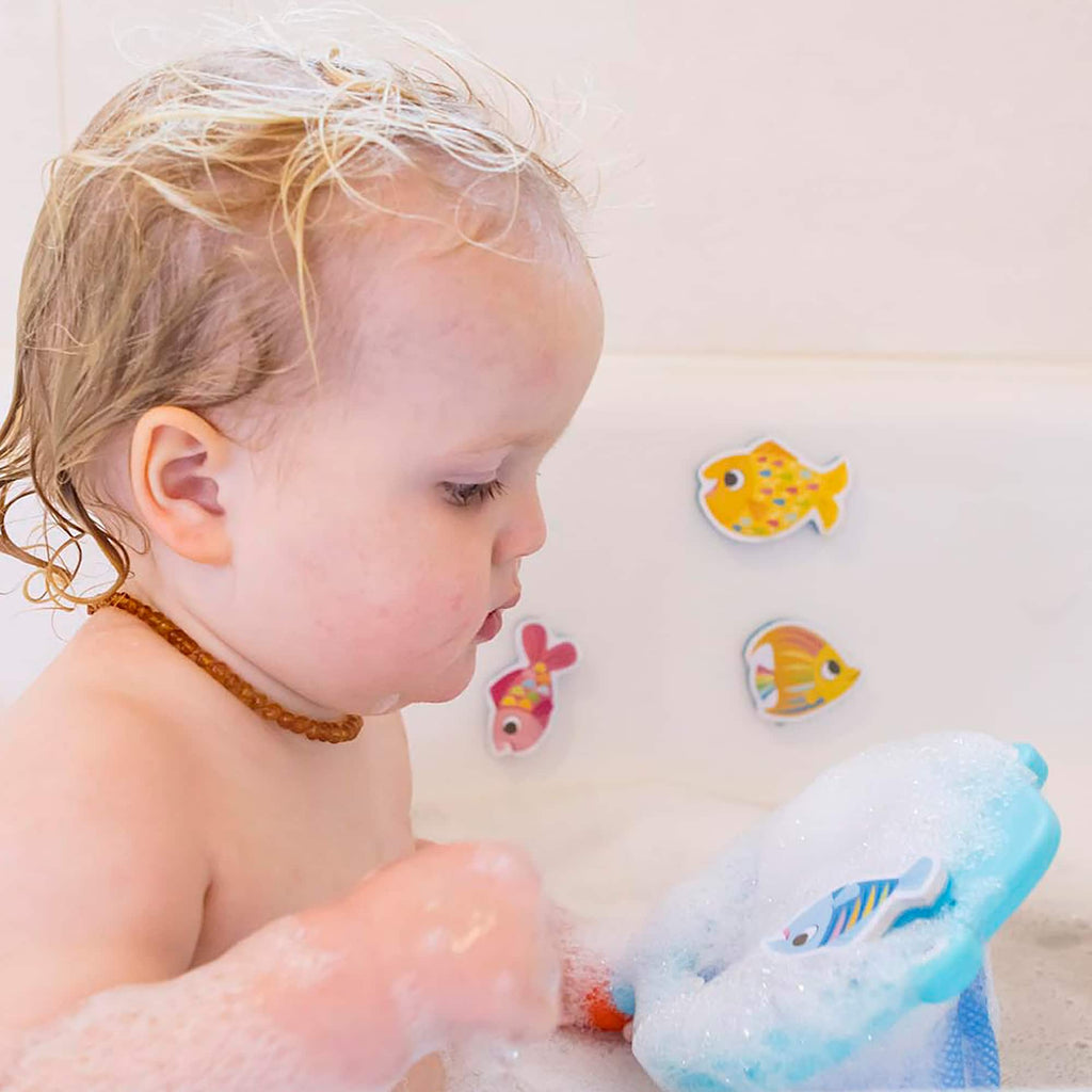 a baby with shark chasey in a bath tub