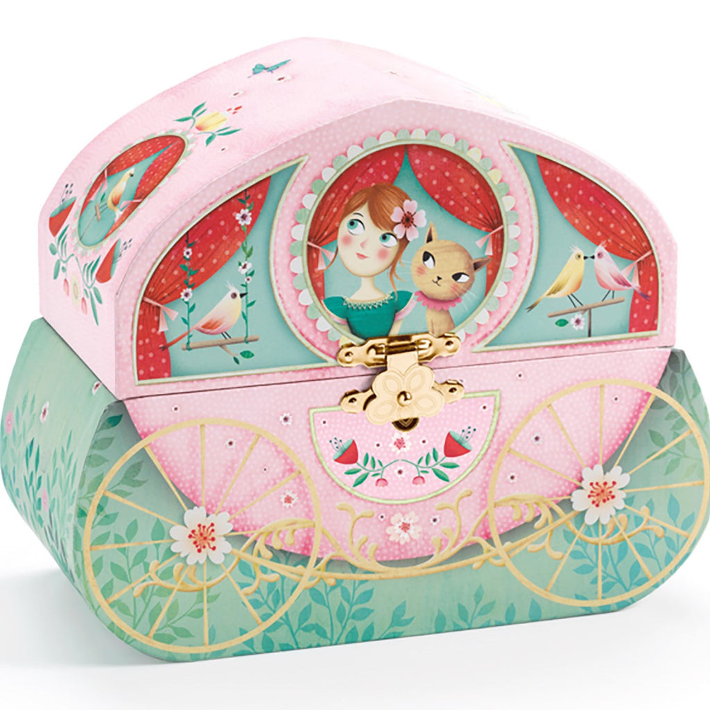 the closed music box showing a carriage with a girl and a cat