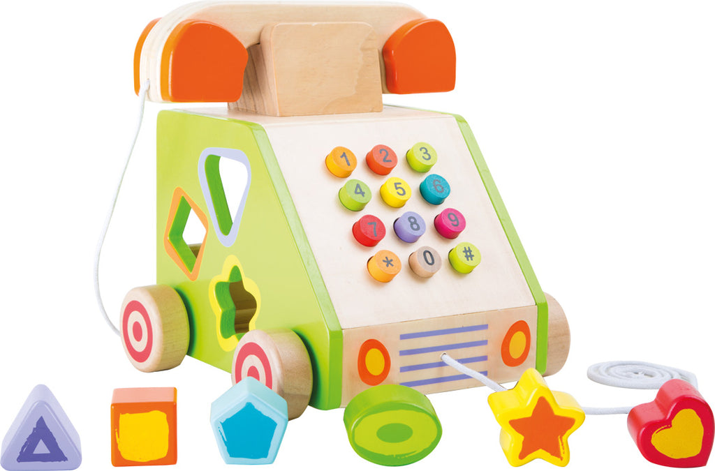 a wooden push button phone on wheels with shaped holes that correspond to colorful shaped blocks