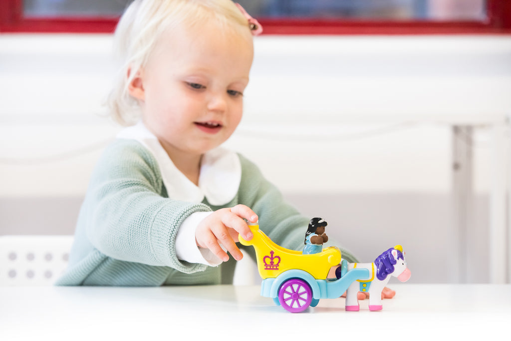 a toddler pushing the phoebe princess carriage