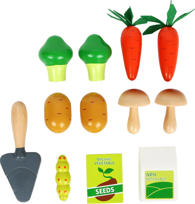 toy potatoes, mushrooms, broccoli, carrots, seeds, fertilizer, catepillar and spade