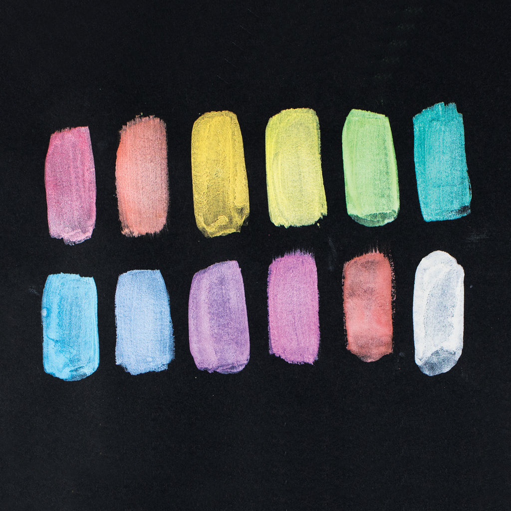 12 color swatches on black paper