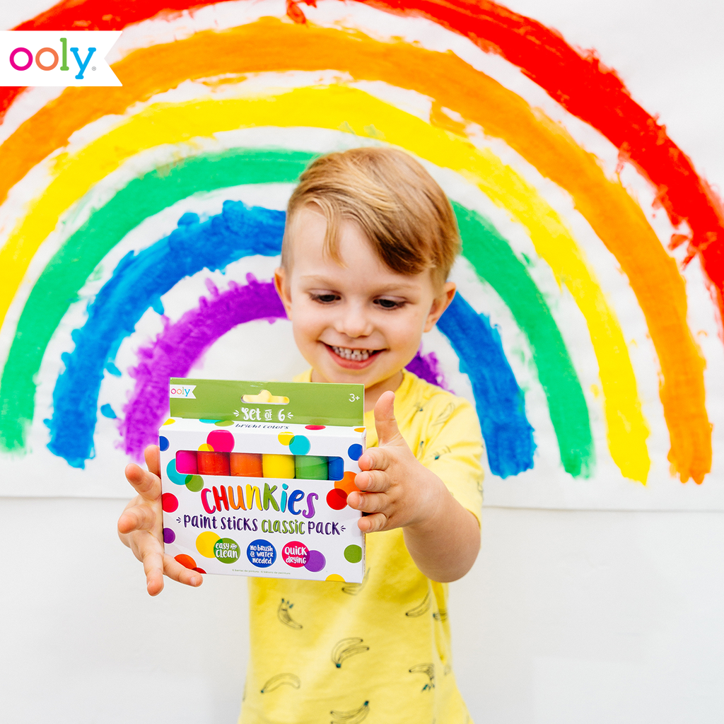 a child holding the box of chunkies paint sticks