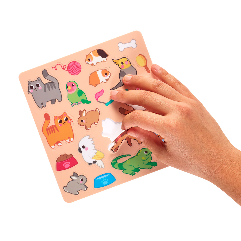 a hand removing a cat sticker