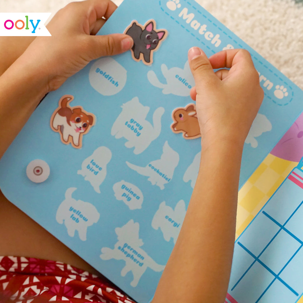 a child applying animal stickers to a match and learn board