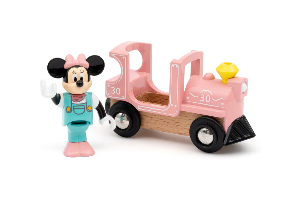 minnie mouse standing by a pink train engine