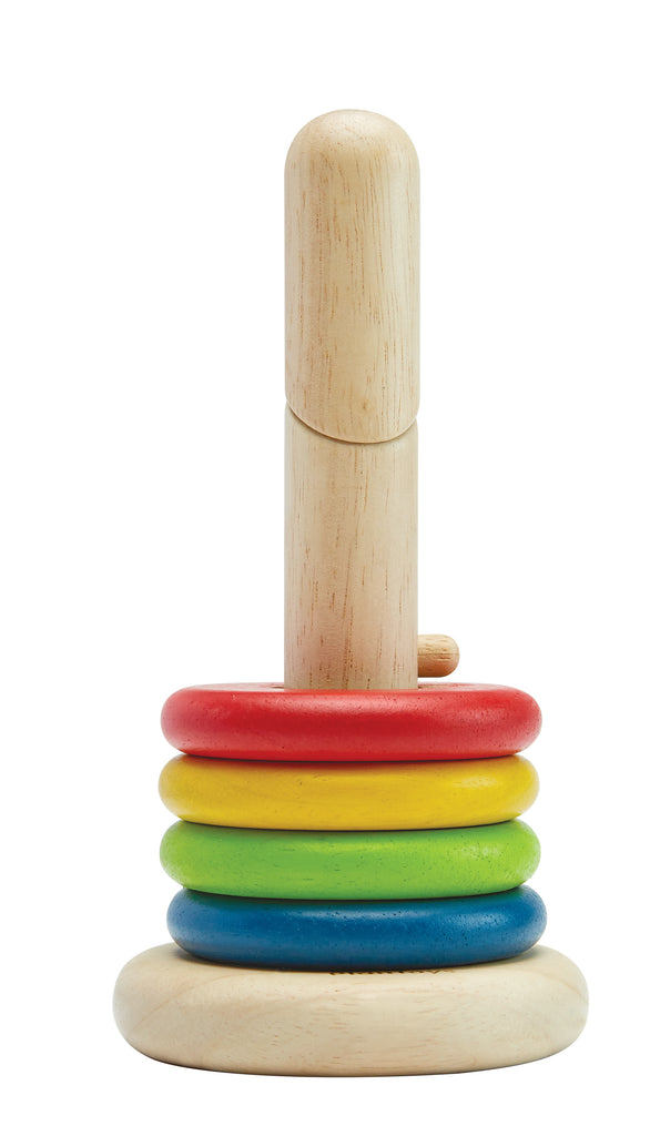 the wooden base with four multicolored rings resting on it