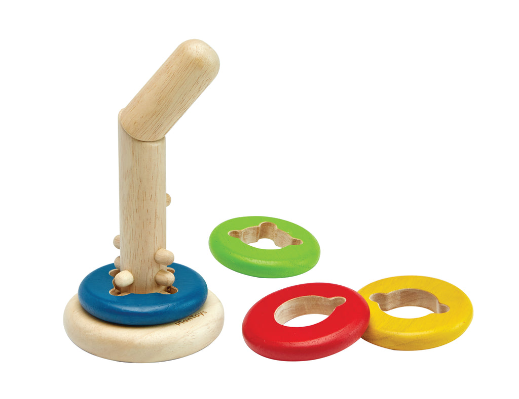 the wooden base with multicolored rings next to it