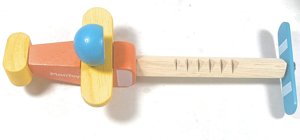 photo of red and yellow toy wooden airplane
