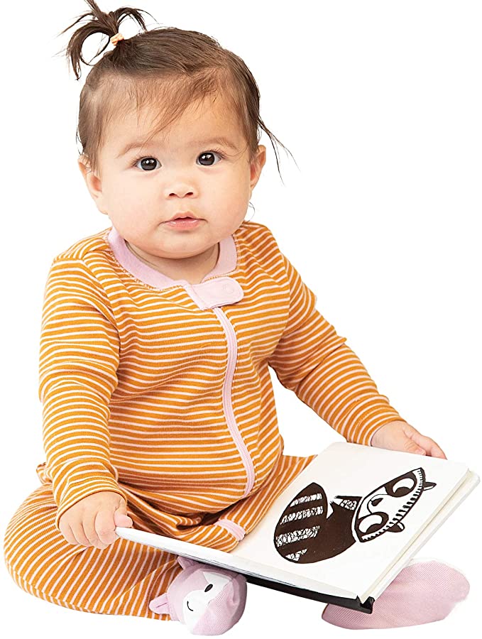 photo of baby enjoying baby zoo book and page with black and white raccoon