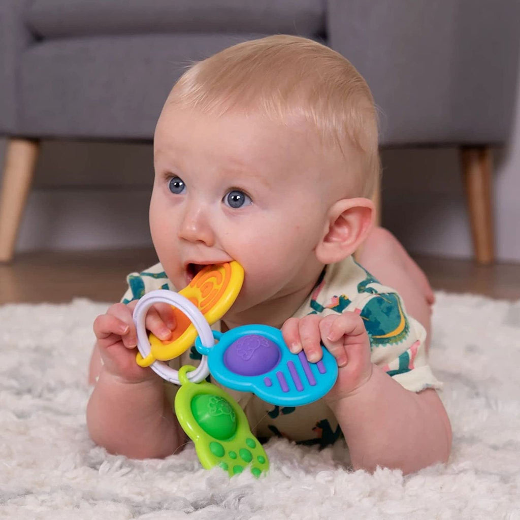 a toddler teething on the dimple clutch
