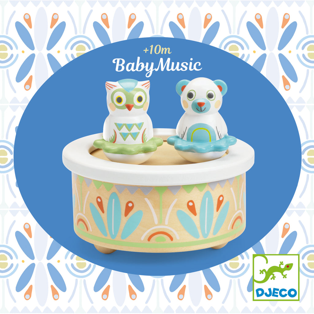 a colorful round music box with an owl and a bear sitting on top