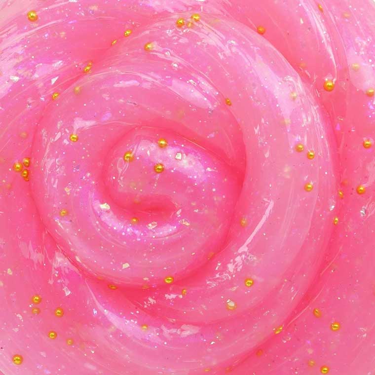 a close up of the pink putty with gold sparkles and beads