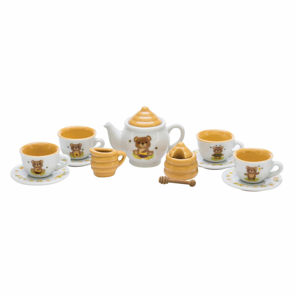the tea set with cups, saucers, tea pot, honey pot, and creamer
