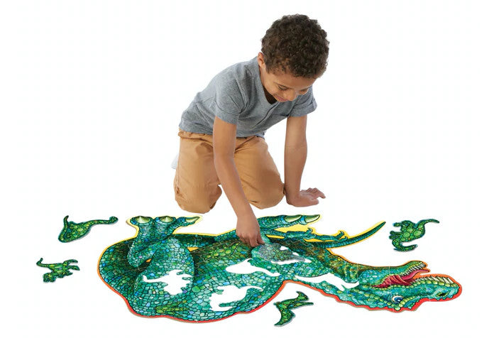 a child putting the shiny dinosaur floor puzzle together