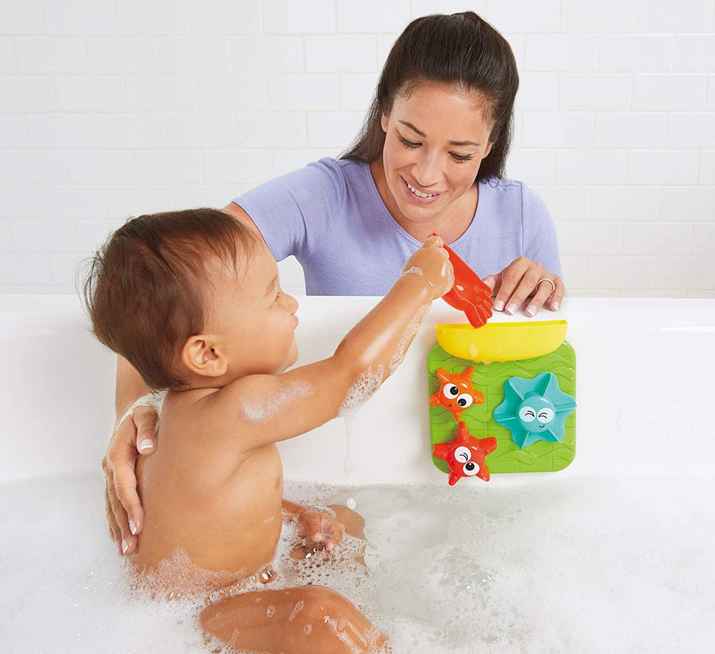 a mother and baby playing with the spin n spill buddies in a bath tub